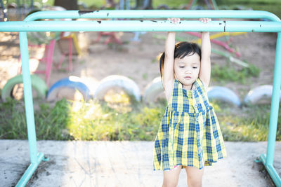 Portrait of boy standing on slide