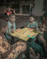 High angle view of siblings sitting on floor