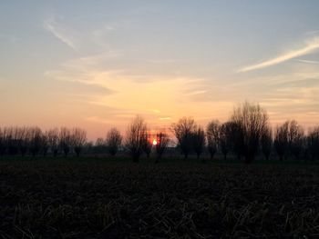 Scenic view of field against sky at sunset