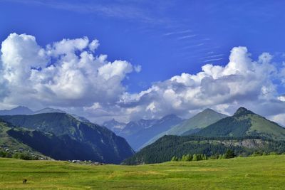 Panoramic shot of countryside landscape against mountain range