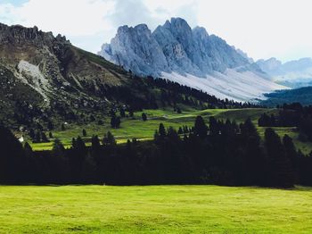 Scenic view of field and mountains against sky