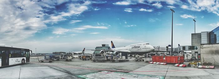 Airplane on airport runway against sky