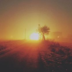 Scenic view of landscape against clear sky during sunset