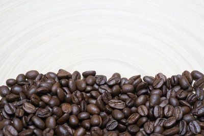 Close-up of coffee beans on wooden table