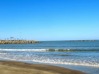 Scenic view of sea against clear blue sky