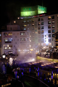 Illuminated buildings in city at night