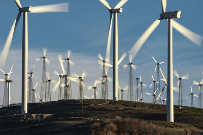 Windmills dot the california mountainside near mojave desert