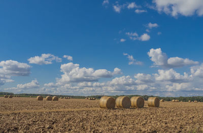 Scenic view of field against cloudy sky