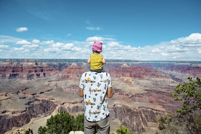 Usa, arizona, grand canyon national park, father and baby girl enjoying the view