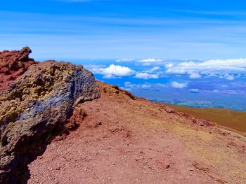 Scenic view of rocky mountains against blue sky
