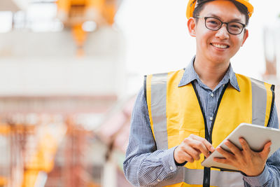 Portrait of smiling young man using smart phone