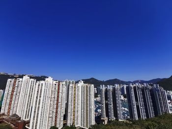 Modern buildings against clear blue sky
