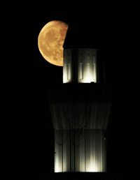 Low angle view of lamp post at night