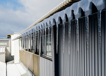 Row of railing against sky during winter