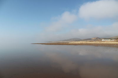 Scenic view of salt lake against sky