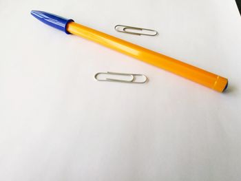 High angle view of colored pencils against white background