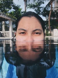 Portrait of teenage girl swimming in pool