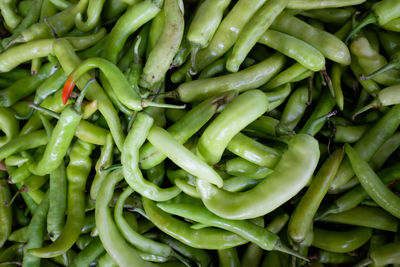 Full frame shot of green chili peppers for sale at market