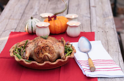 Close-up of roast chicken in container on table