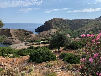 Scenic view of sea and mountains against sky