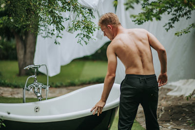 Midsection of man standing in bathroom