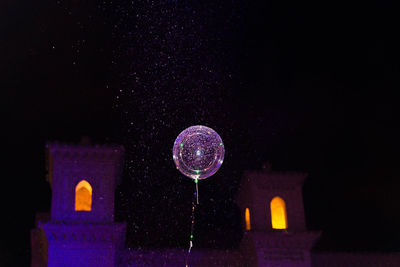 Low angle view of illuminated moon against sky at night