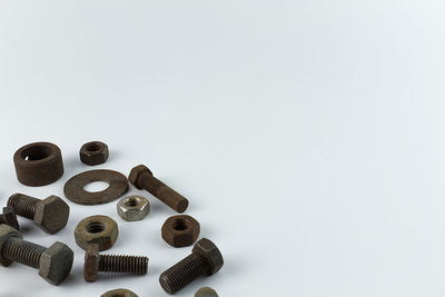 High angle view of coins on table against white background