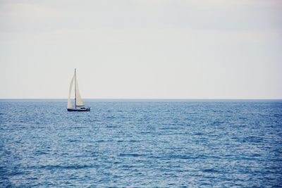 Boat sailing on sea against sky