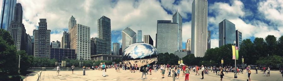 Panoramic view of people on modern buildings in city