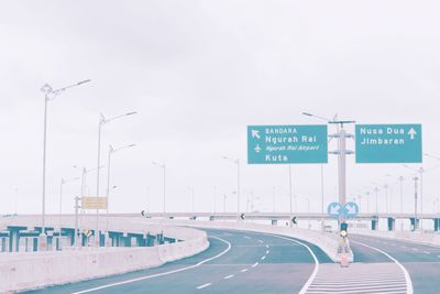 Road sign against clear sky