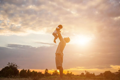 Man playing against sky during sunset