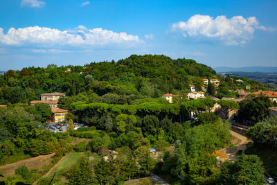 Scenic view of trees and buildings against sky