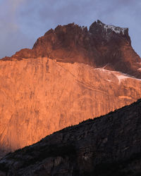 Low angle view of rocky mountains against sky