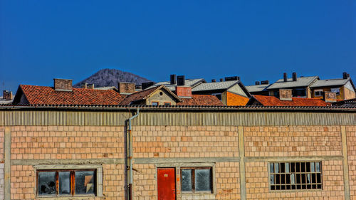 Houses against clear blue sky