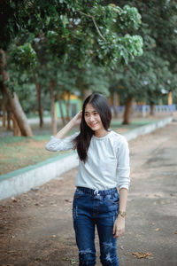 Smiling young woman standing outdoors