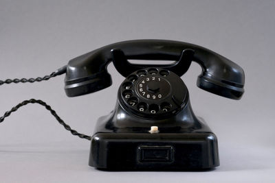 Close-up of telephone booth on table