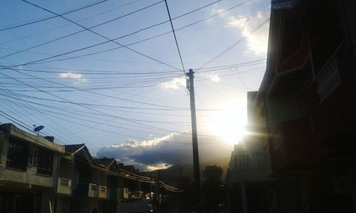 Low angle view of electricity pylon against sky