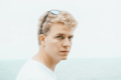 Portrait of mid adult man against sea