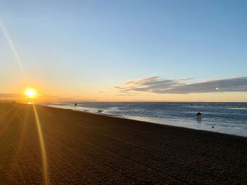 Scenic view of beach against sky during sunset