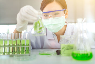 Close-up of female scientist experimenting in laboratory