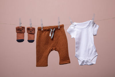 Close-up of clothes drying against white background