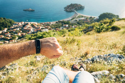 People on rock by sea