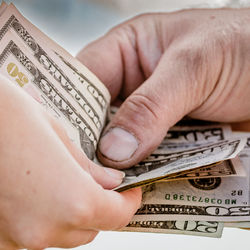 Cropped hand of person holding paper currency