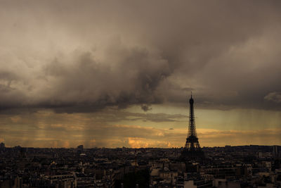 View of cityscape against cloudy sky