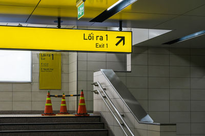 Low angle view of man standing on escalator