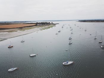 High angle view of sailboats in sea against sky