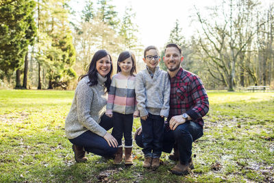 Happy parents pose for photo with their son and daughter.