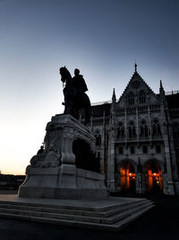 Low angle view of statue against sky at dusk