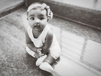 Portrait of cute girl sitting on floor