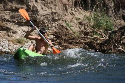 Man kayaking in river